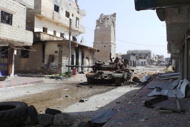 Abandoned tank is seen on a street near the damaged minaret of the Omari mosque in Deraa